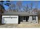 Charming single-story home featuring a gray exterior, attached garage, and stone accents near the entrance at 600 Hicksmill Rd, Oxford, NC 27565