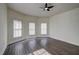 Spacious bedroom with a ceiling fan and three large windows at 613 Mclean St, Spring Hope, NC 27882