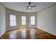Bright bedroom features hardwood floors, large windows, and a ceiling fan at 613 Mclean St, Spring Hope, NC 27882