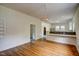 Spacious dining room featuring hardwood floors, wainscoting, and a unique chandelier at 613 Mclean St, Spring Hope, NC 27882