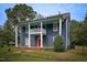 Charming two-story home features blue siding, red doors, and a quaint porch at 613 Mclean St, Spring Hope, NC 27882
