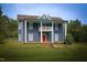 Inviting two-story house boasts a covered porch and well-maintained lawn at 613 Mclean St, Spring Hope, NC 27882
