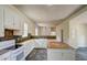 Bright kitchen features white cabinets, stone backsplash, and open design leading into the living area at 613 Mclean St, Spring Hope, NC 27882