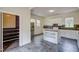 Updated kitchen with stainless steel refrigerator, center island, and lots of cabinet space at 613 Mclean St, Spring Hope, NC 27882