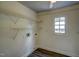 Functional laundry room with wire shelving and a window for natural light at 613 Mclean St, Spring Hope, NC 27882