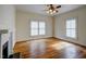 Bright living room with hardwood floors, fireplace, and a ceiling fan at 613 Mclean St, Spring Hope, NC 27882