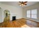 Inviting living room featuring a fireplace, hardwood floors, and a ceiling fan at 613 Mclean St, Spring Hope, NC 27882