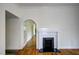 Living room boasting hardwood floors, a fireplace, and an arched doorway at 613 Mclean St, Spring Hope, NC 27882