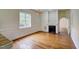 Cozy living room with a fireplace, hardwood floors, and wainscoting detail at 613 Mclean St, Spring Hope, NC 27882
