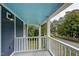 Covered porch with white railings offers a serene outdoor space at 613 Mclean St, Spring Hope, NC 27882