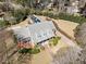 Aerial view of a charming brick and gray home with solar panels, beautifully landscaped yard, and inviting curb appeal at 6336 Wrenwood Ave, Raleigh, NC 27607