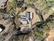 Bird's eye view of a well-maintained property surrounded by lush trees and featuring a long, winding driveway at 6336 Wrenwood Ave, Raleigh, NC 27607