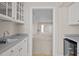 The bar area boasts a sink, storage cabinets, and a wine fridge at 6336 Wrenwood Ave, Raleigh, NC 27607
