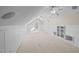 Spacious bonus room with bright white wainscoting, neutral carpet, and built-in shelving, perfect for storage or display at 6336 Wrenwood Ave, Raleigh, NC 27607