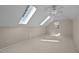 Bonus room featuring bright skylights, neutral walls, carpeted floors, and natural light from a window at 6336 Wrenwood Ave, Raleigh, NC 27607