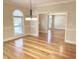 Bright, airy room with hardwood floors, large arched window, and classic trim details at 6336 Wrenwood Ave, Raleigh, NC 27607