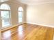 Sun-filled room with hardwood floors and arched windows overlooking the front yard at 6336 Wrenwood Ave, Raleigh, NC 27607