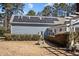 Back of house featuring solar panels and a patio with a pergola covered area at 6336 Wrenwood Ave, Raleigh, NC 27607