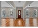 Grand foyer with hardwood floors, arched windows and a charming front door at 6336 Wrenwood Ave, Raleigh, NC 27607