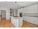 Spacious kitchen featuring a kitchen island, white cabinets, and ample counter space at 6336 Wrenwood Ave, Raleigh, NC 27607