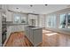 Bright kitchen featuring an island gas cooktop and plenty of cabinet and countertop space at 6336 Wrenwood Ave, Raleigh, NC 27607
