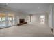 Large living room with brick fireplace and double doors to sunroom at 6336 Wrenwood Ave, Raleigh, NC 27607