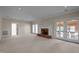 Spacious living room with brick fireplace and french doors that lead to the sunroom at 6336 Wrenwood Ave, Raleigh, NC 27607