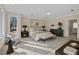 Staged main bedroom featuring a king bed, seating, side tables, and artwork, creating a stylish and inviting space at 6336 Wrenwood Ave, Raleigh, NC 27607