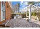 Brick outdoor kitchen with built-in grill and pergola-covered patio area, ideal for entertaining at 6336 Wrenwood Ave, Raleigh, NC 27607