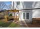 Secluded backyard featuring a cozy bench area with a trellis, accessible through French doors at 6713 Brookhollow Dr, Raleigh, NC 27615