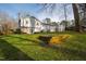 Rear view of the home showcasing the open yard and a multi-level deck, perfect for enjoying the outdoors at 6713 Brookhollow Dr, Raleigh, NC 27615