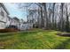 Expansive backyard with a well-maintained lawn, mature trees, and a multi-level deck at 6713 Brookhollow Dr, Raleigh, NC 27615