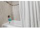 Bathroom featuring tiled walls, shower and bathtub at 6713 Brookhollow Dr, Raleigh, NC 27615