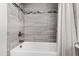 Tile bathtub with shower and a neutral colored shower curtain at 6713 Brookhollow Dr, Raleigh, NC 27615