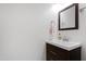 Modern half bath featuring a dark-stained vanity and stylish fixtures at 6713 Brookhollow Dr, Raleigh, NC 27615