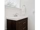 Powder room with dark vanity, brushed nickel faucet, towel ring, and window at 6713 Brookhollow Dr, Raleigh, NC 27615