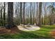 Charming fire pit area with outdoor seating, nestled among the trees for a cozy ambiance at 6713 Brookhollow Dr, Raleigh, NC 27615