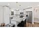 Bright kitchen features white cabinets, stainless appliances, and island with seating at 6713 Brookhollow Dr, Raleigh, NC 27615