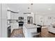 Bright kitchen features white cabinets, stainless appliances, and island with seating at 6713 Brookhollow Dr, Raleigh, NC 27615