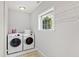 Functional laundry room featuring washer, dryer, window, and overhead drying rack at 6713 Brookhollow Dr, Raleigh, NC 27615