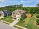 Spacious home with a lush lawn and mature trees, showcasing its desirable neighborhood location at 701 Prince Dr, Holly Springs, NC 27540