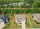 An aerial view of the home showcasing its landscaped yard and the surrounding neighborhood at 701 Prince Dr, Holly Springs, NC 27540
