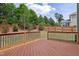 Large wooden deck overlooking a well-maintained backyard with wooden fence and greenery at 701 Prince Dr, Holly Springs, NC 27540