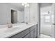 Elegant bathroom featuring a double vanity with sleek gray cabinets and modern fixtures at 701 Prince Dr, Holly Springs, NC 27540