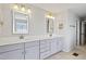 Bathroom with double vanity, gray cabinets and quartz countertop offering a sleek and modern feel at 701 Prince Dr, Holly Springs, NC 27540