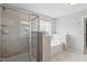 Bathroom featuring tiled shower and soaking tub at 701 Prince Dr, Holly Springs, NC 27540