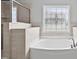 Bright bathroom with a soaking tub and decorative window adding elegance to the room at 701 Prince Dr, Holly Springs, NC 27540