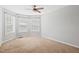 Cozy bedroom filled with natural light from large windows and a ceiling fan at 701 Prince Dr, Holly Springs, NC 27540