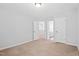 Spacious bedroom with neutral tones, carpeted floors and en suite bathroom entrance at 701 Prince Dr, Holly Springs, NC 27540