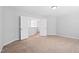 Open and airy bedroom with double doors leading to the hallway at 701 Prince Dr, Holly Springs, NC 27540